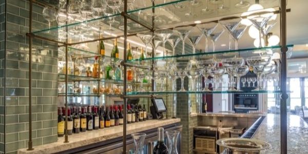 Barton Hills Country Club bar stemware on glass shelves