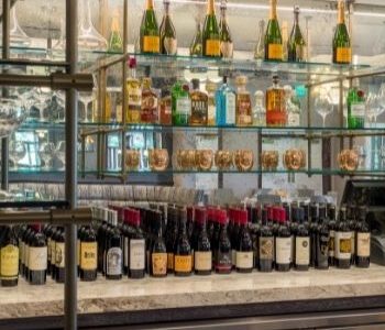 Barton Hills Country Club bar with brass glass shelves and refrigeration