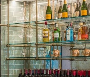 Barton Hills Country Club behind the bar glass shelves and tile work